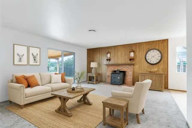 a view of an empty room with a fireplace and a window