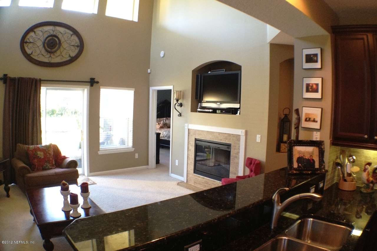 6092 White Tip Road Jacksonville, FL 32258 - Photo 11 of 32 a living room with furniture a flat screen tv and a fireplace