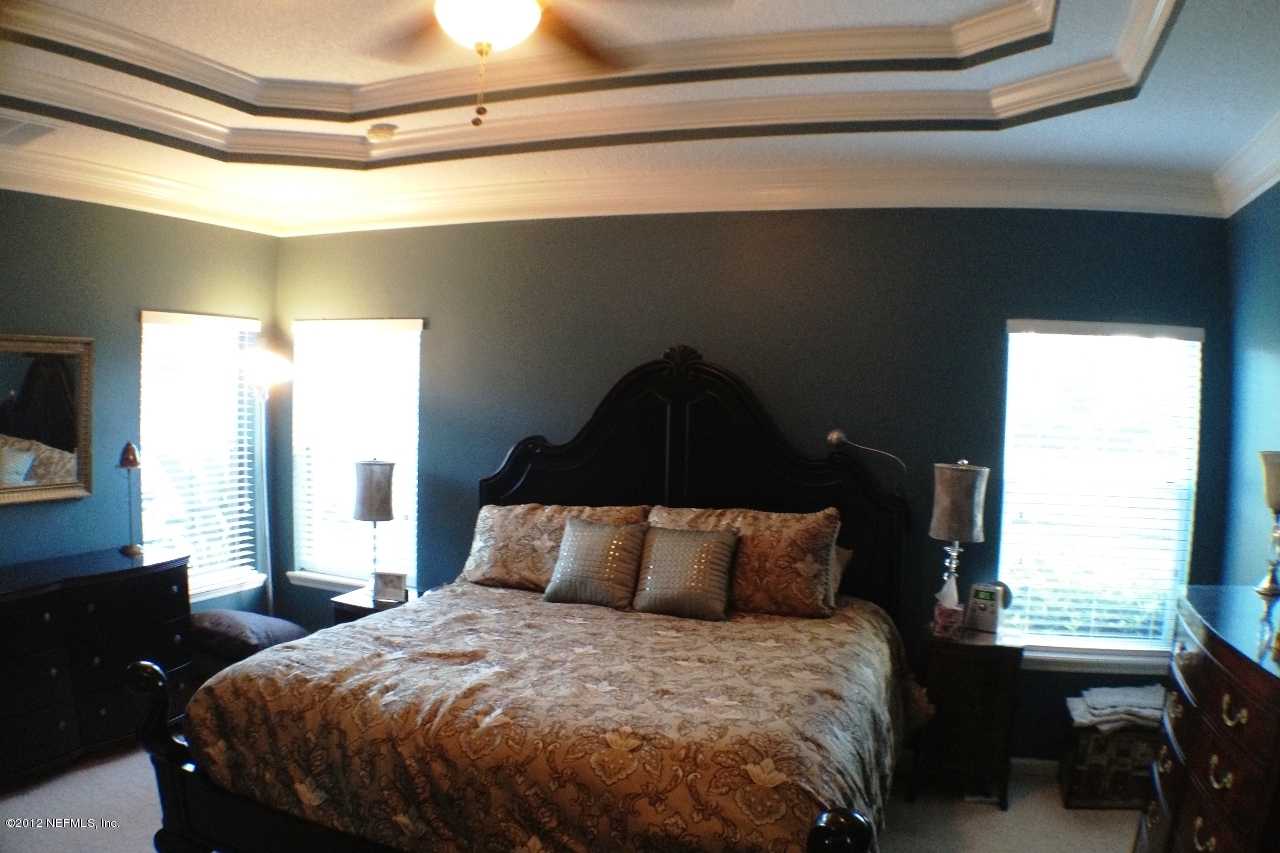 6092 White Tip Road Jacksonville, FL 32258 - Photo 14 of 32 a bed sitting in a bedroom next to a window