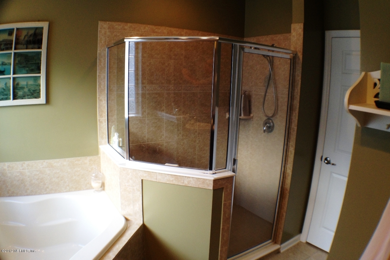 6092 White Tip Road Jacksonville, FL 32258 - Photo 17 of 32 a bathroom with a bathtub and a shower