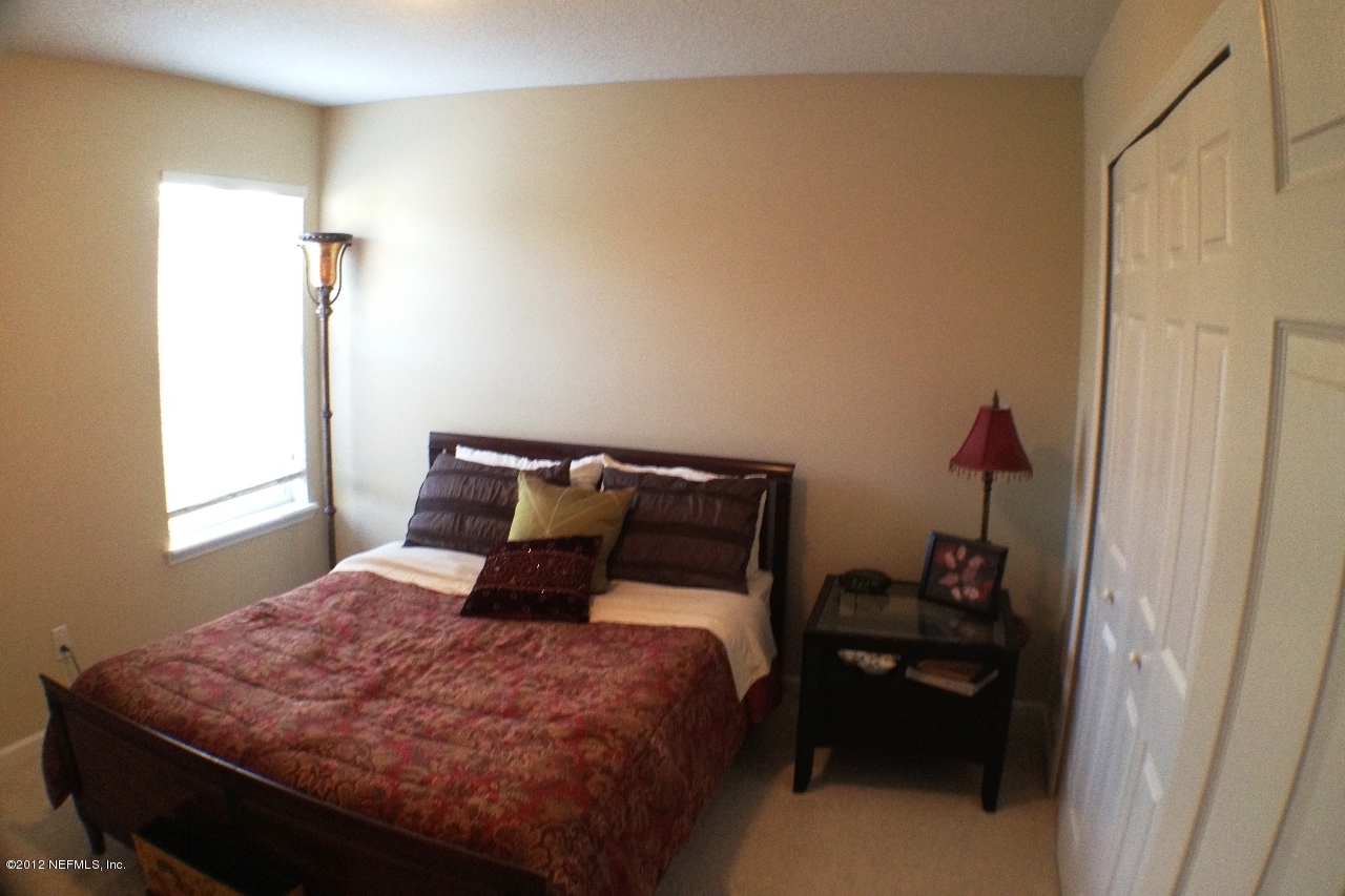 6092 White Tip Road Jacksonville, FL 32258 - Photo 23 of 32 a bedroom with a bed and a window