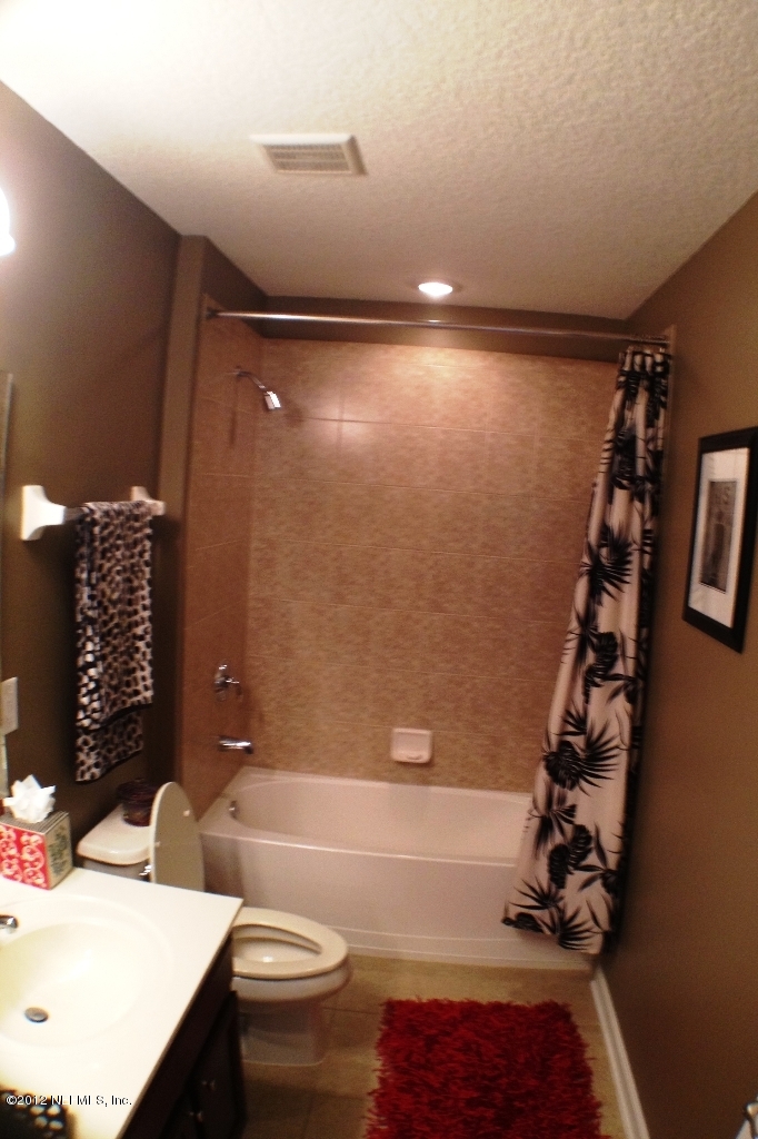 6092 White Tip Road Jacksonville, FL 32258 - Photo 26 of 32 a bathroom with a sink a toilet and tub