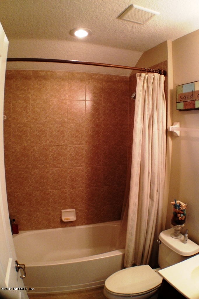 6092 White Tip Road Jacksonville, FL 32258 - Photo 27 of 32 a bathroom with a sink and a mirror