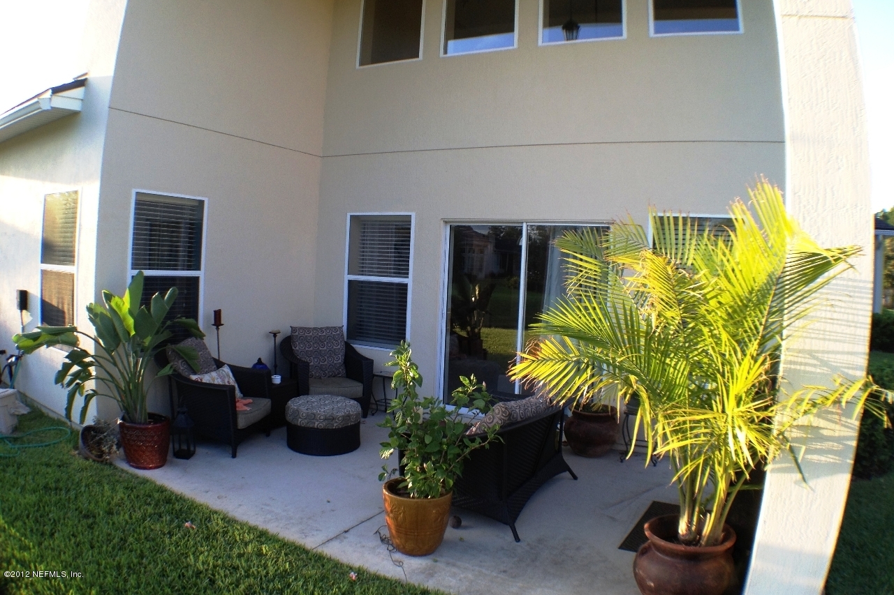 6092 White Tip Road Jacksonville, FL 32258 - Photo 28 of 32 a potted plant sitting in front of a house