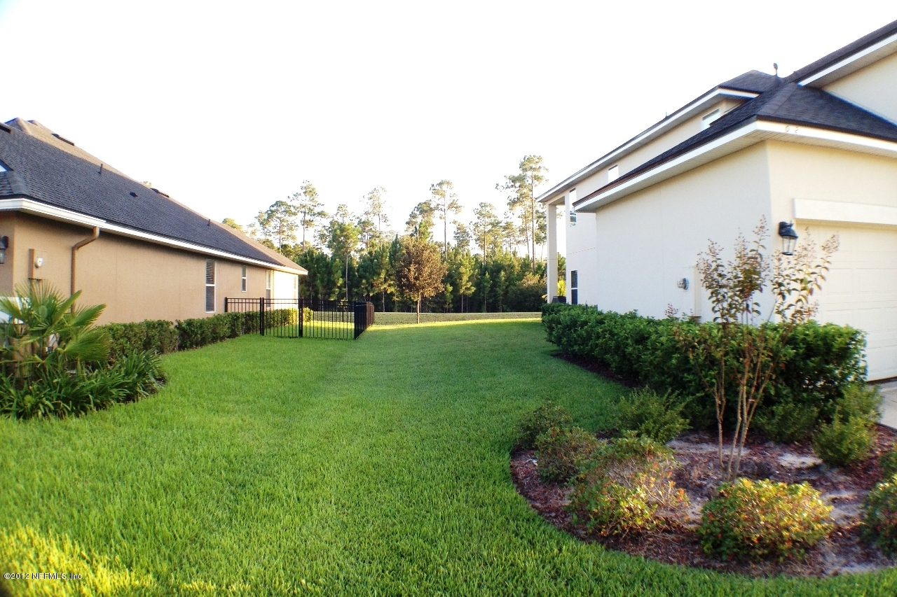 6092 White Tip Road Jacksonville, FL 32258 - Photo 31 of 32 a view of a backyard with plants and a garden