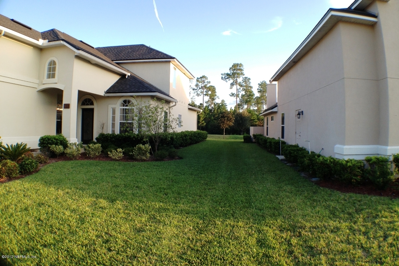 6092 White Tip Road Jacksonville, FL 32258 - Photo 32 of 32 a view of a white house next to a yard with potted plants