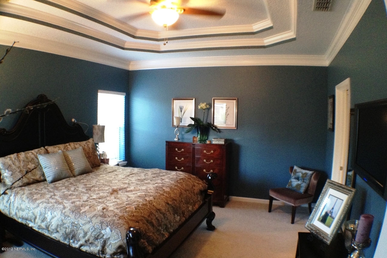 6092 White Tip Road Jacksonville, FL 32258 - Photo 4 of 32 a bedroom with a bed and a mirror on the dresser