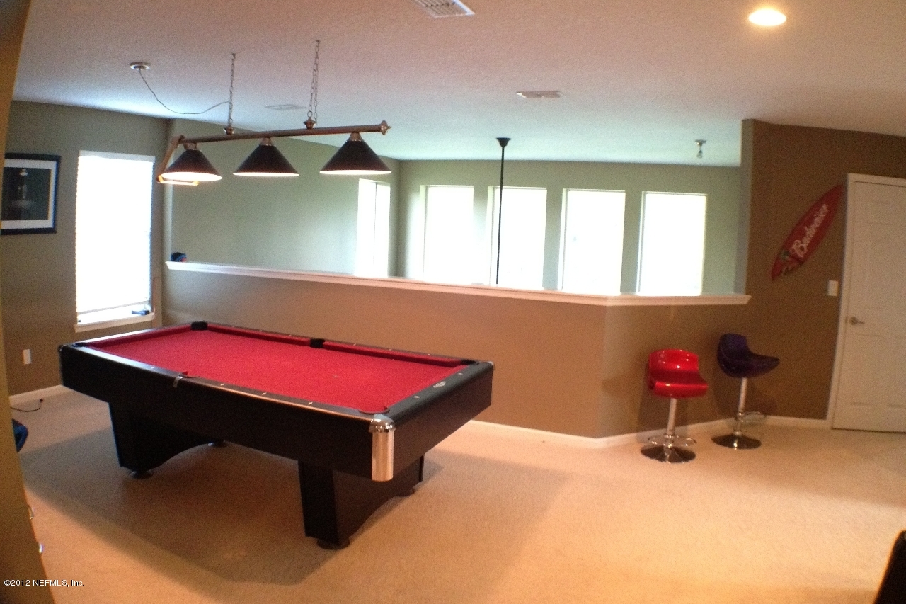 6092 White Tip Road Jacksonville, FL 32258 - Photo 5 of 32 a room with pool table wooden floor and windows