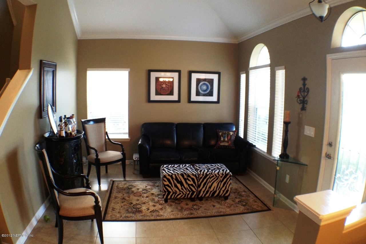 6092 White Tip Road Jacksonville, FL 32258 - Photo 7 of 32 a living room with furniture rug and wooden floor