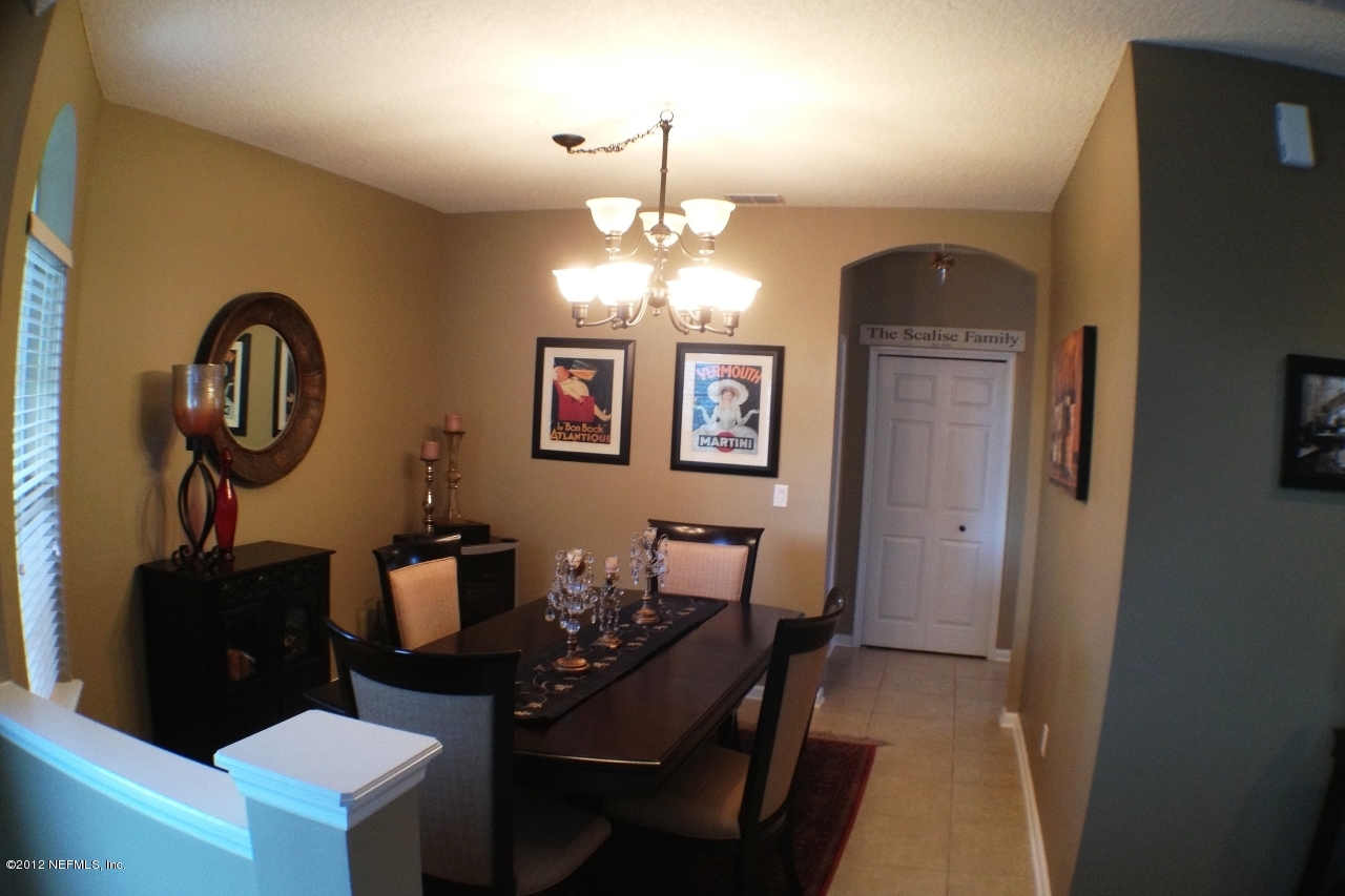 6092 White Tip Road Jacksonville, FL 32258 - Photo 8 of 32 a dining room with chandelier and wooden floor