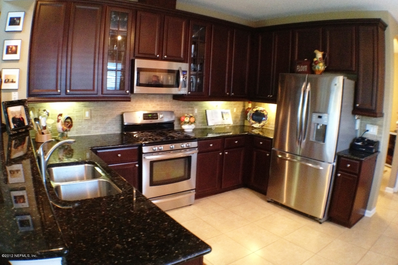 6092 White Tip Road Jacksonville, FL 32258 - Photo 9 of 32 a kitchen with stainless steel appliances granite countertop a stove a refrigerator and a sink