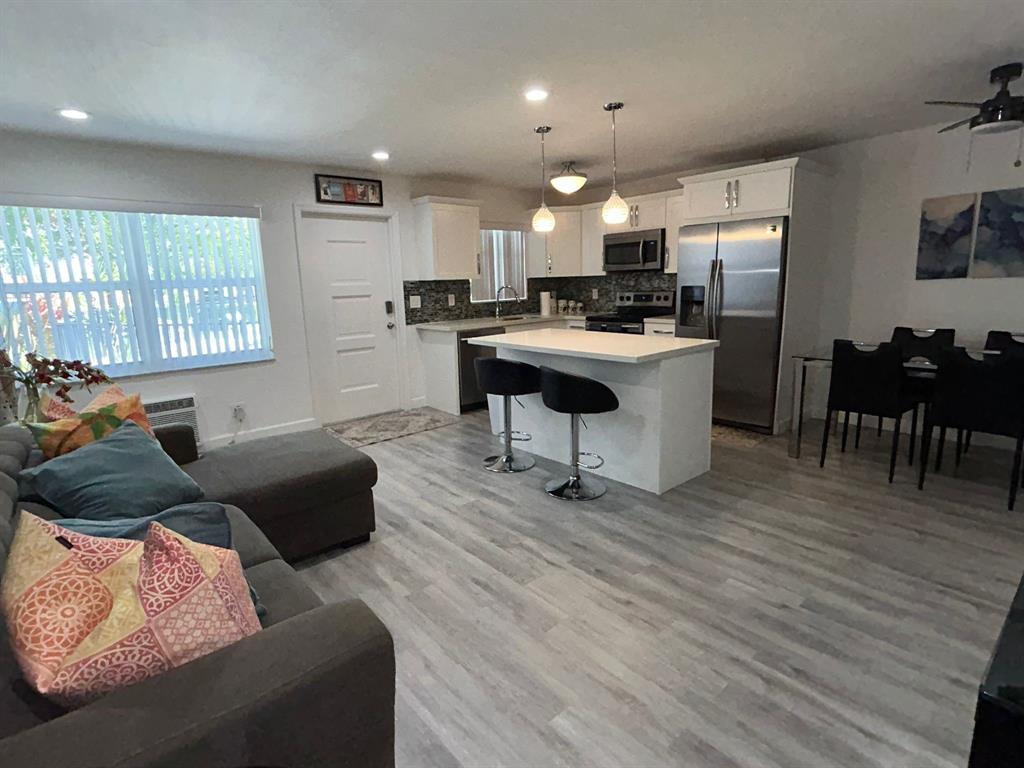 3510 Harrison Street, Unit 4 Hollywood, FL 33021 - Photo 2 of 7 a living room with furniture and a wooden floor