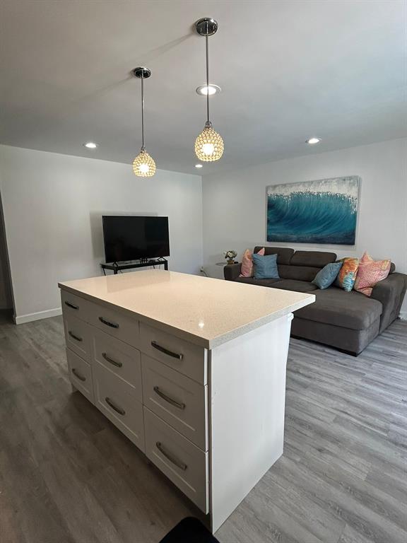 3510 Harrison Street, Unit 4 Hollywood, FL 33021 - Photo 3 of 7 a view of a kitchen counter space a wooden floor and a fireplace