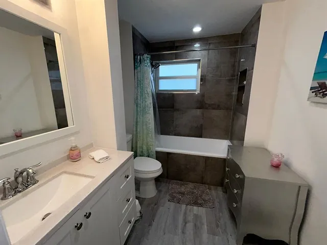 a bathroom with a sink toilet and shower
