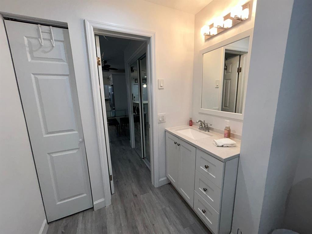 3510 Harrison Street, Unit 4 Hollywood, FL 33021 - Photo 7 of 7 a bathroom with a sink a mirror a vanity and a toilet
