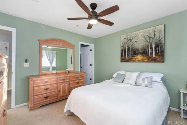 a bedroom with a bed and a painting on the wall