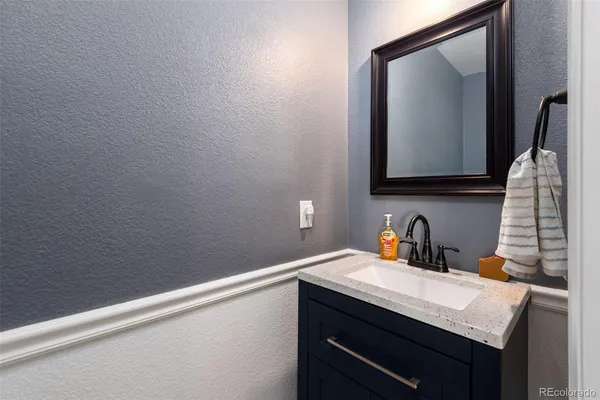 a bathroom with a sink vanity and a mirror