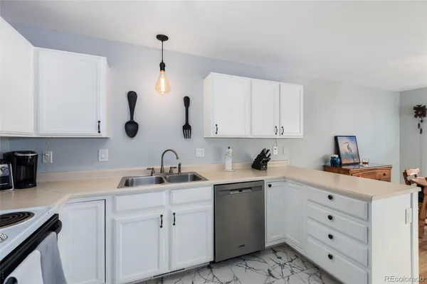a kitchen with cabinets appliances and a sink
