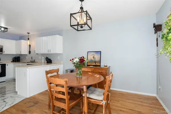 a dining room with wooden floor and breakfast area