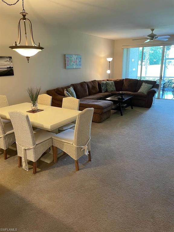 8085 Celeste Drive, Unit 812 Naples, FL 34113 - Photo 4 of 9 a living room with furniture and a large window