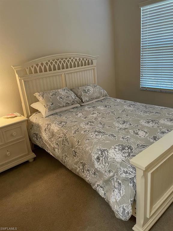 8085 Celeste Drive, Unit 812 Naples, FL 34113 - Photo 6 of 9 a bedroom with a bed and a window