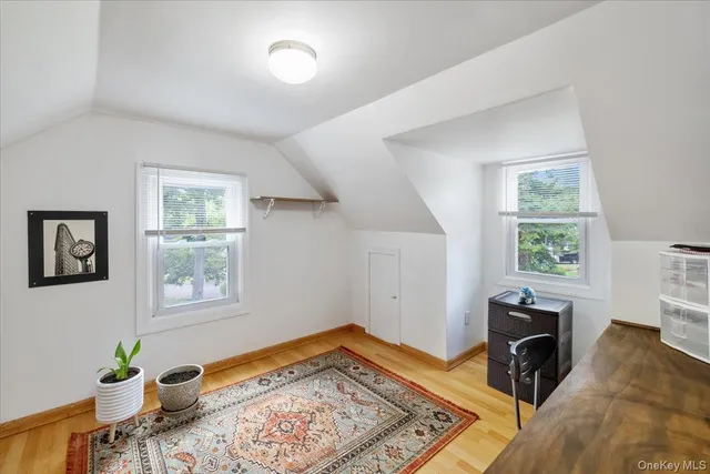 a view of a bedroom with furniture and a window