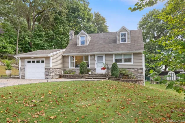 a front view of house with yard and green space