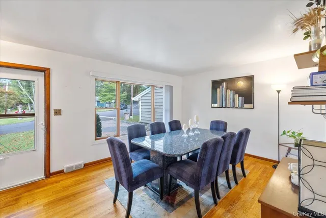 a view of a dining room with furniture and wooden floor
