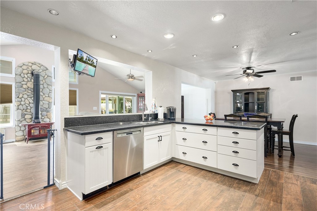 3976 Russ Court Simi Valley, CA 93063 - Photo 6 of 47 a large kitchen with granite countertop a sink and dishwasher a stove with wooden floor