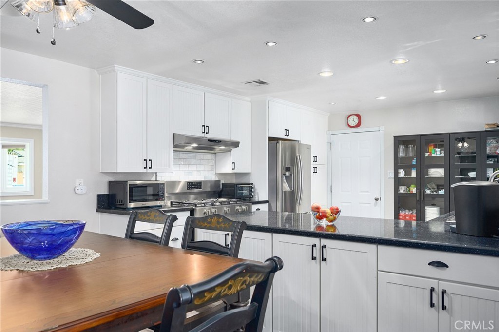 3976 Russ Court Simi Valley, CA 93063 - Photo 9 of 47 a kitchen with stainless steel appliances granite countertop a sink a stove and a refrigerator