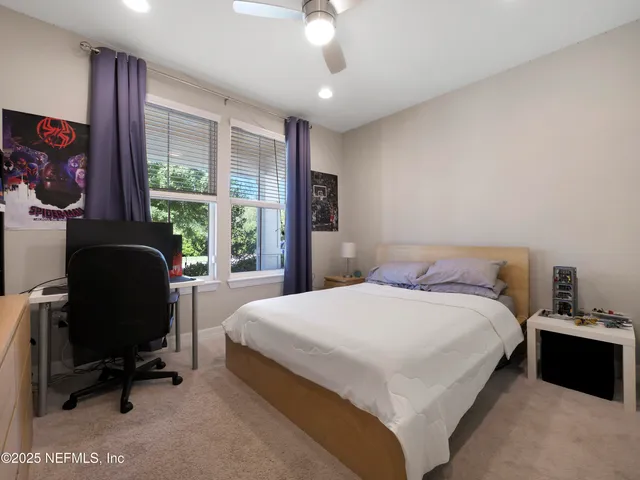 a bedroom with a bed chair and a window