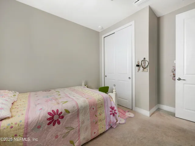 a bedroom with a bed and a mirror