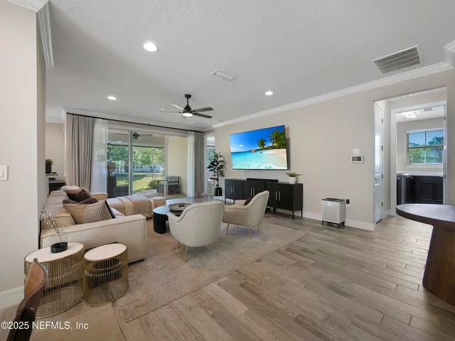 a living room with fireplace furniture and a large window