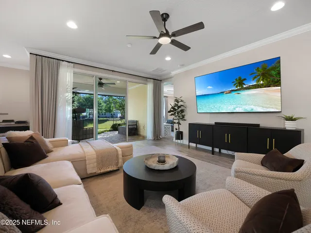 a living room with furniture a rug and a large window