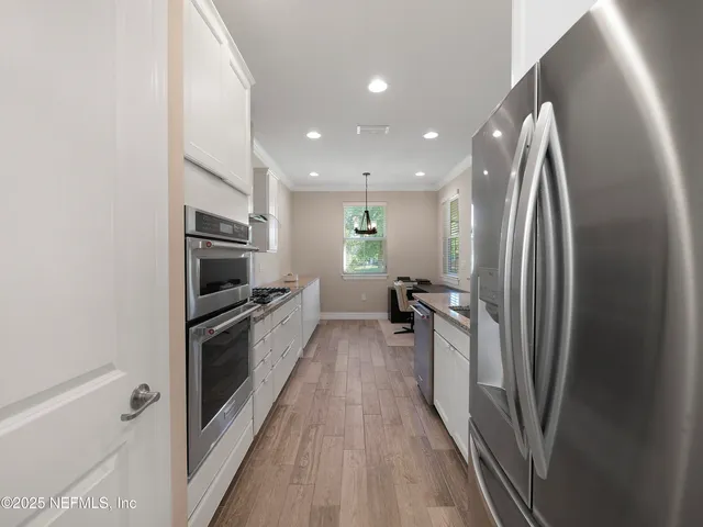 a kitchen with stainless steel appliances a refrigerator and a stove