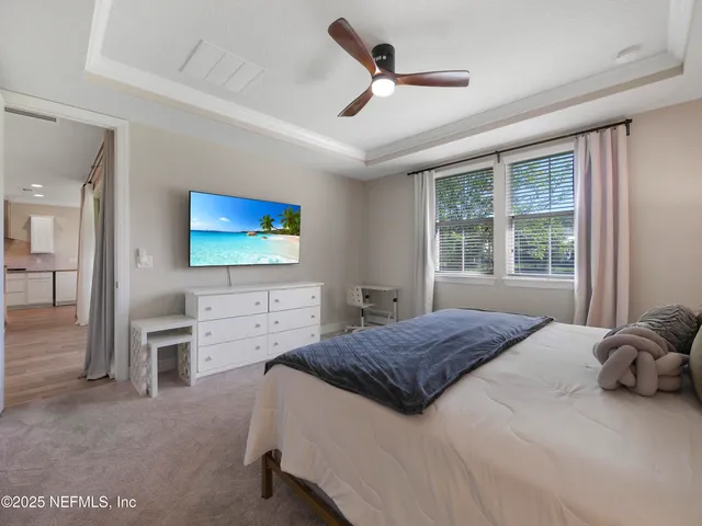 a spacious bathroom with a granite countertop sink and a mirror