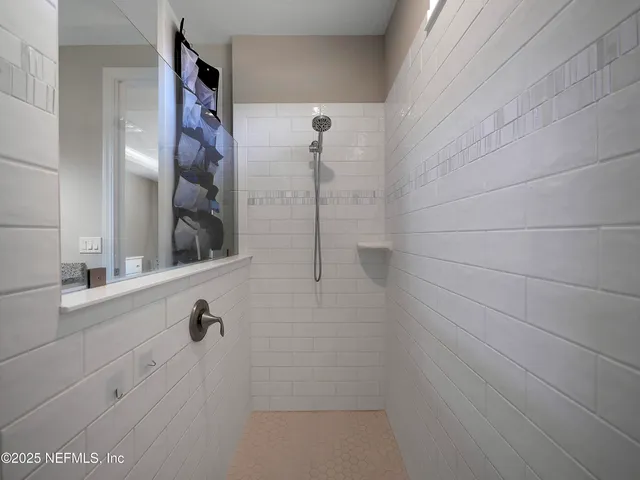 a view of walk in closet with clothes