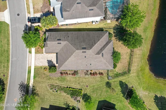 an aerial view of residential houses with outdoor space
