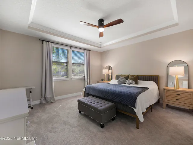 a spacious bedroom with a bed and a window