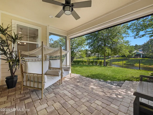 a view of a porch with furniture and garden