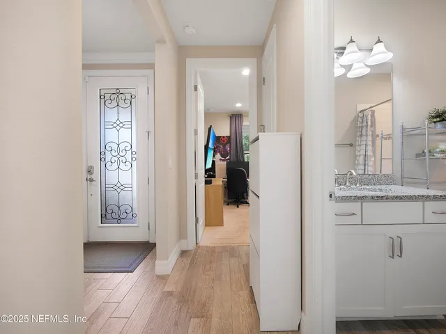 a view of a hallway with wooden floor and staircase