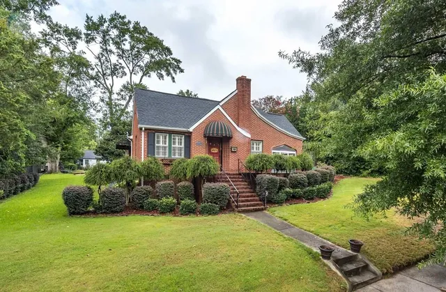 a front view of house with yard and green space