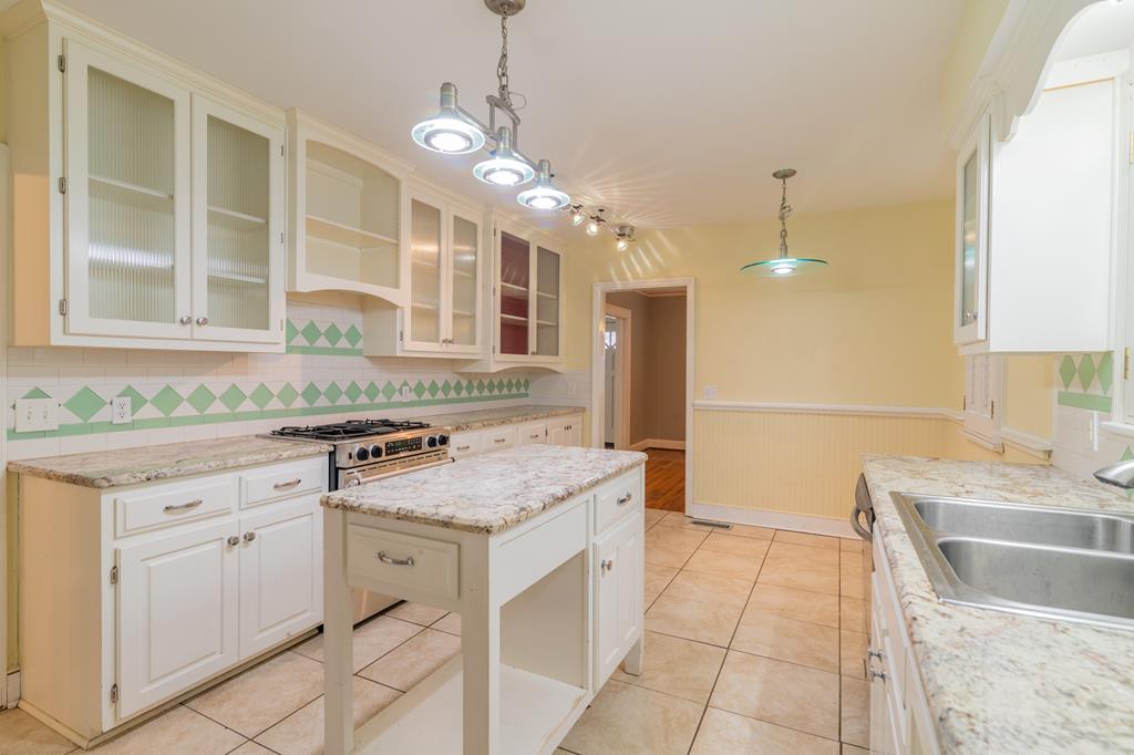 1505 16th Avenue Columbus, GA 31901 - Photo 11 of 22 a kitchen with a sink stove and cabinets