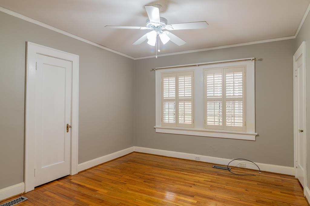 1505 16th Avenue Columbus, GA 31901 - Photo 12 of 22 a view of an empty room with window and wooden floor