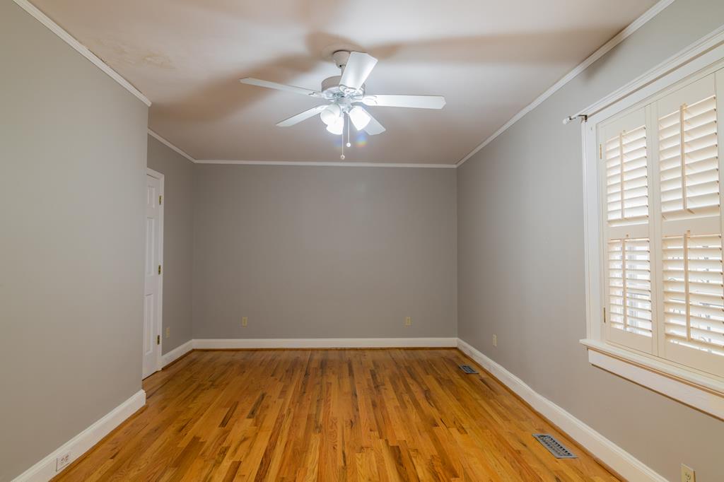 1505 16th Avenue Columbus, GA 31901 - Photo 13 of 22 wooden floor in an empty room with a window