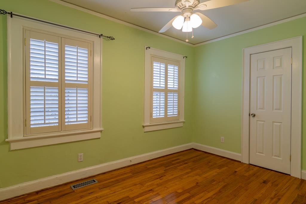 1505 16th Avenue Columbus, GA 31901 - Photo 15 of 22 a view of an empty room with wooden floor and a window