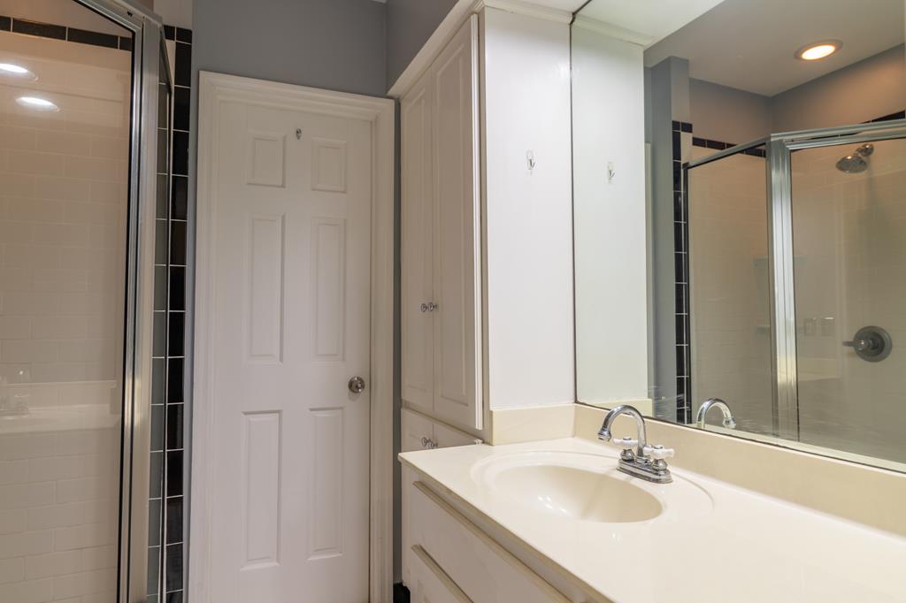 1505 16th Avenue Columbus, GA 31901 - Photo 16 of 22 a bathroom with a shower sink vanity and mirror