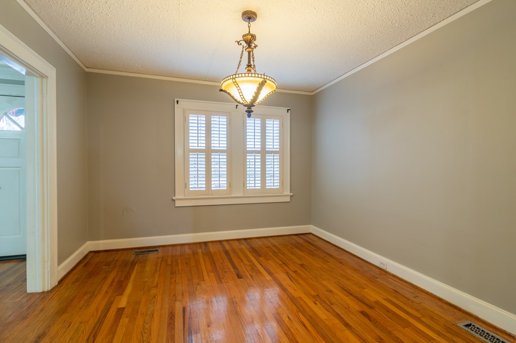 1505 16th Avenue Columbus, GA 31901 - Photo 7 of 22 a view of empty room with wooden floor and fan