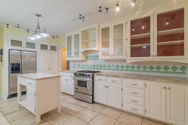 a kitchen with a sink stove and cabinets