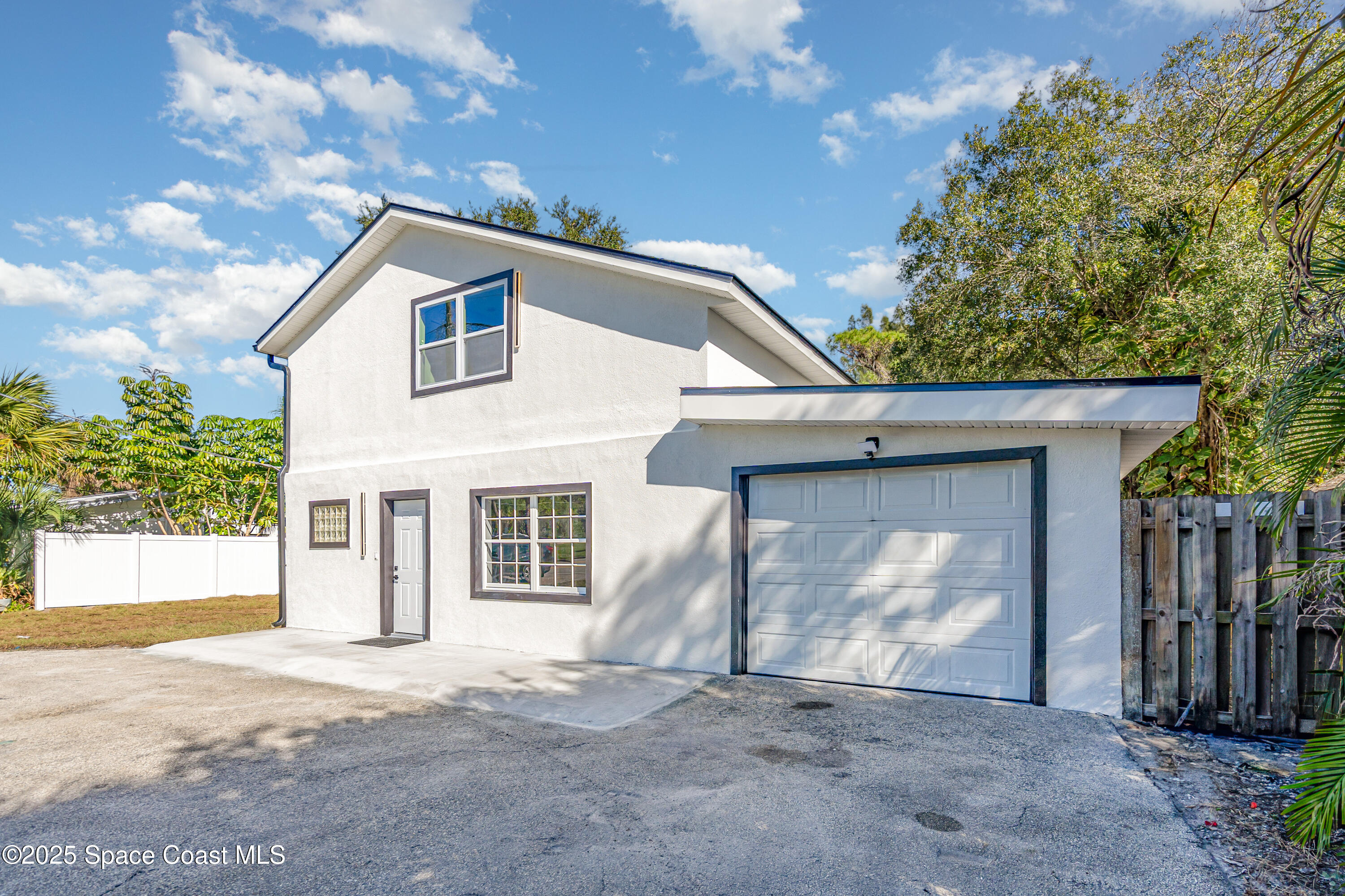 1735 Marywood Road Melbourne, FL 32934 - Photo 1 of 25 a house with trees in the background